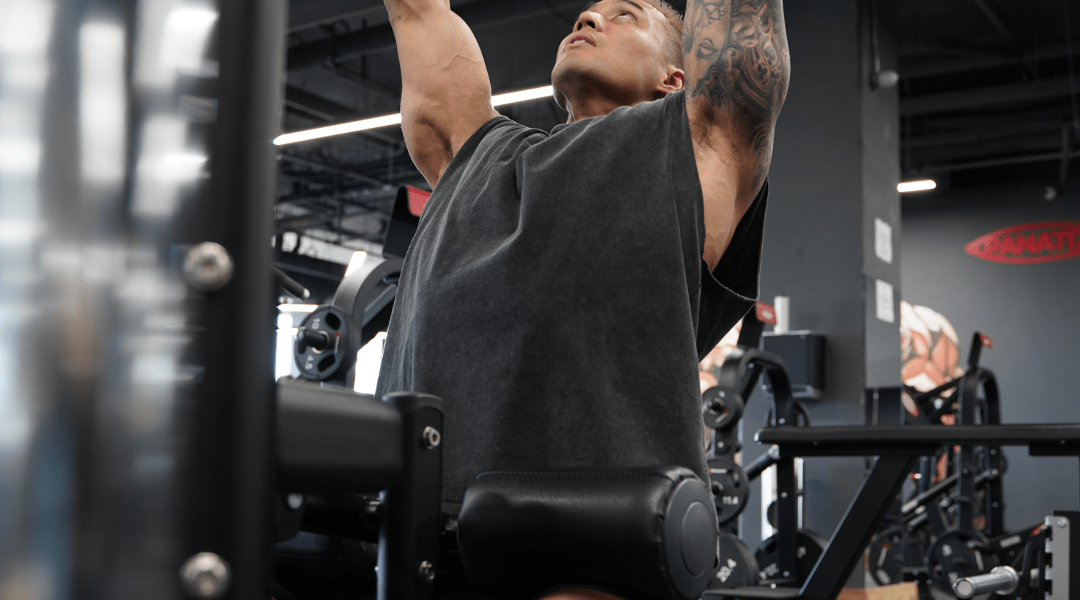 Lifter in the Devoteewear Reign oversized tank and Drive 7-inch short mid lat pulldown